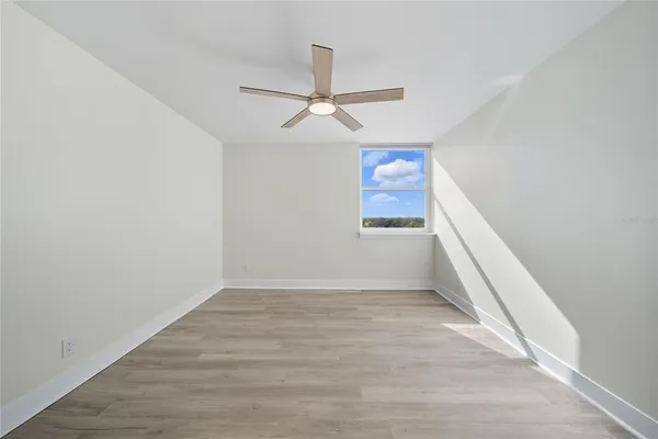 a view of walk in closet with empty racks