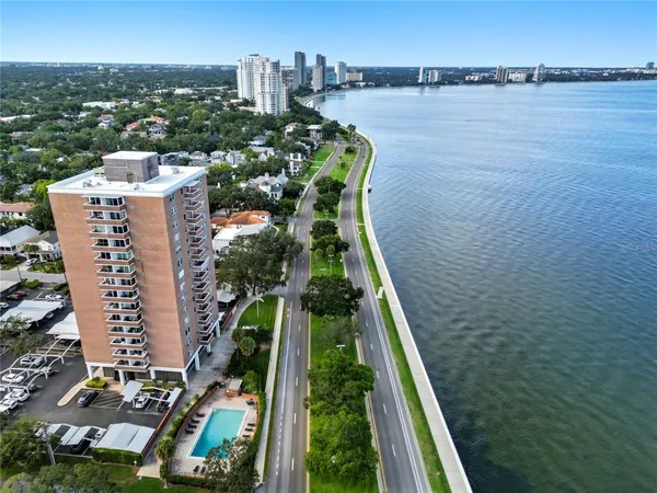an aerial view of a house with a garden and lake view