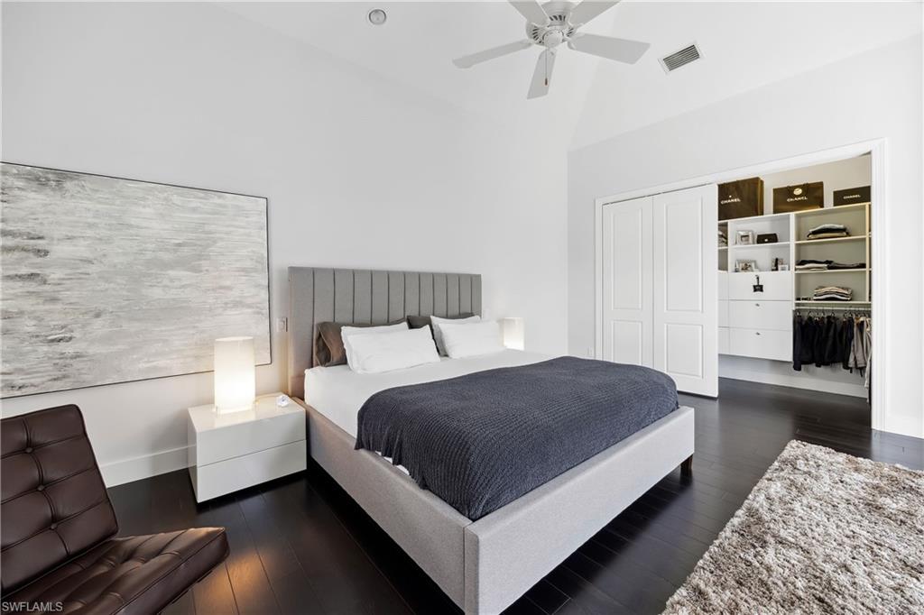 299 Mermaids Bight Naples, FL 34103 - Photo 11 of 28 a bedroom with a bed couch and a window