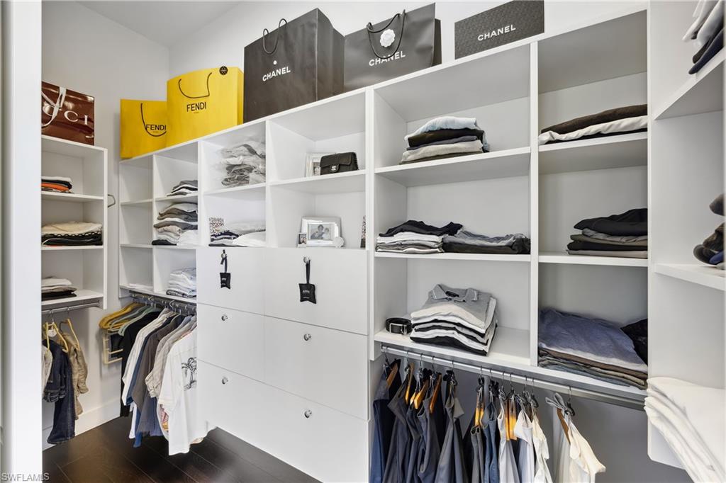299 Mermaids Bight Naples, FL 34103 - Photo 14 of 28 a view of walk in closet with clothes and shoes