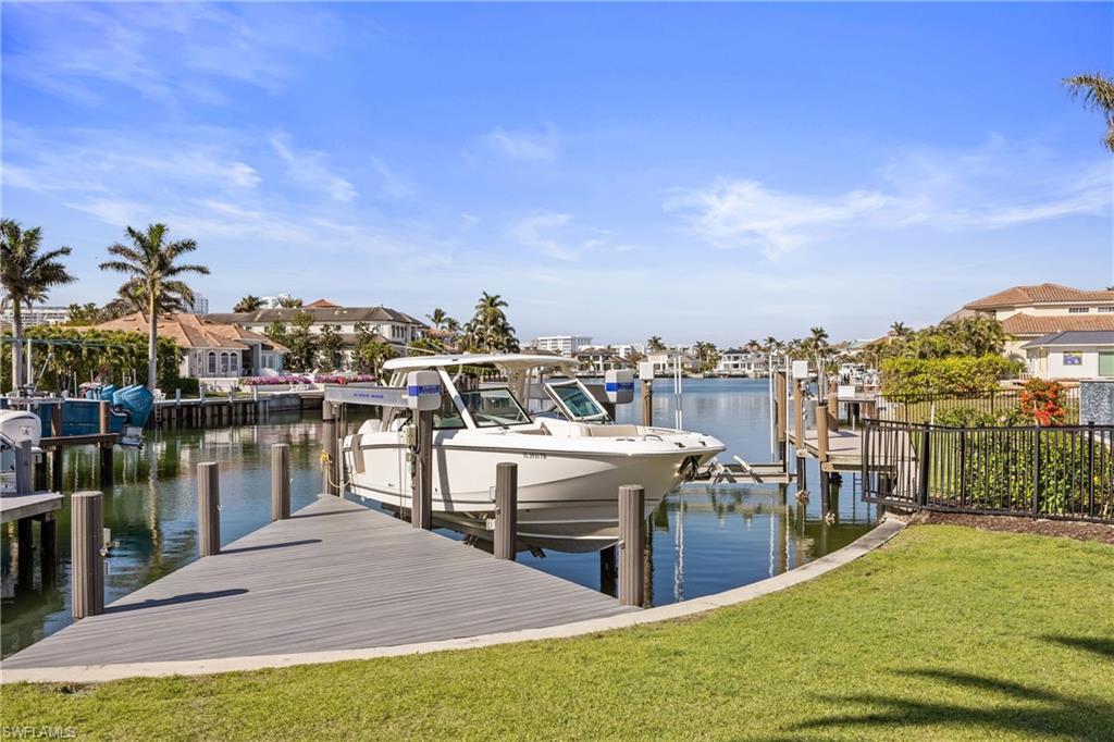 299 Mermaids Bight Naples, FL 34103 - Photo 2 of 28 a view of a rooftop deck and dining room