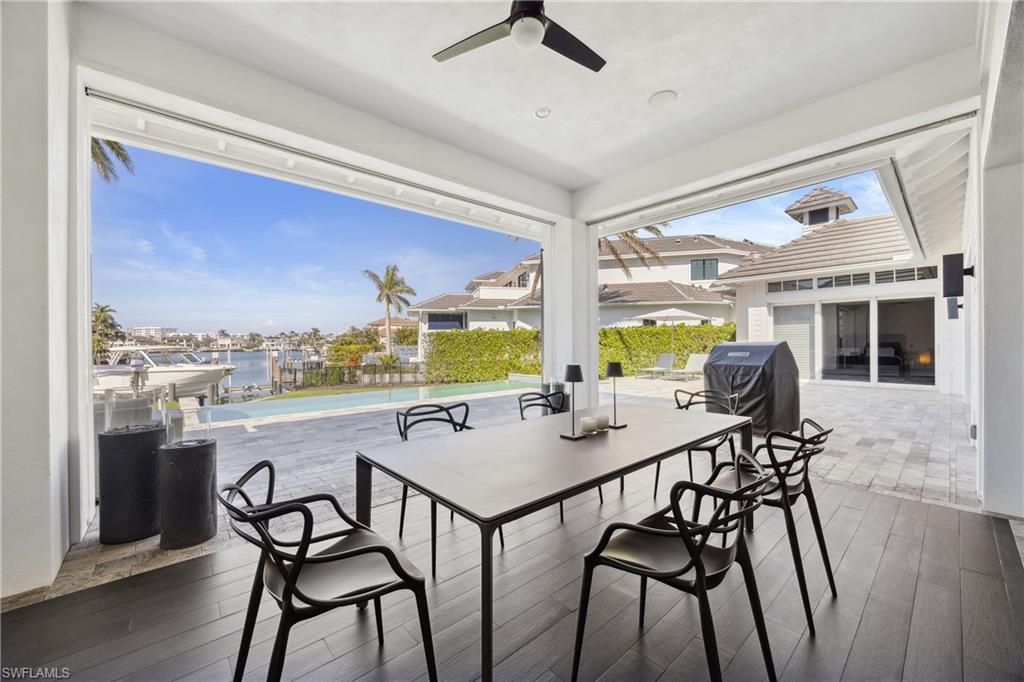 299 Mermaids Bight Naples, FL 34103 - Photo 23 of 28 a view of a dining room with furniture window and outside view