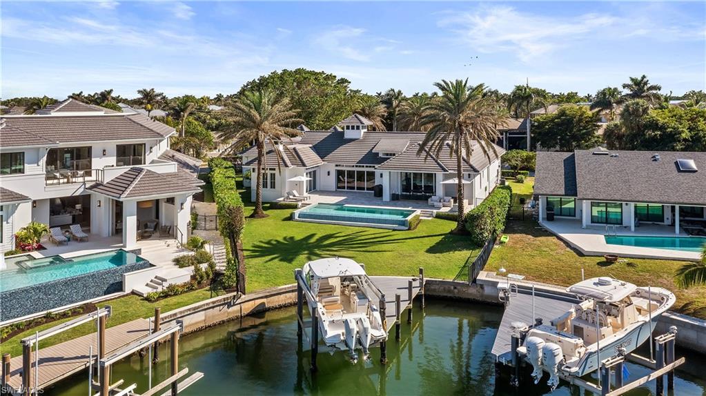 299 Mermaids Bight Naples, FL 34103 - Photo 25 of 28 aerial view of a house with swimming pool and porch