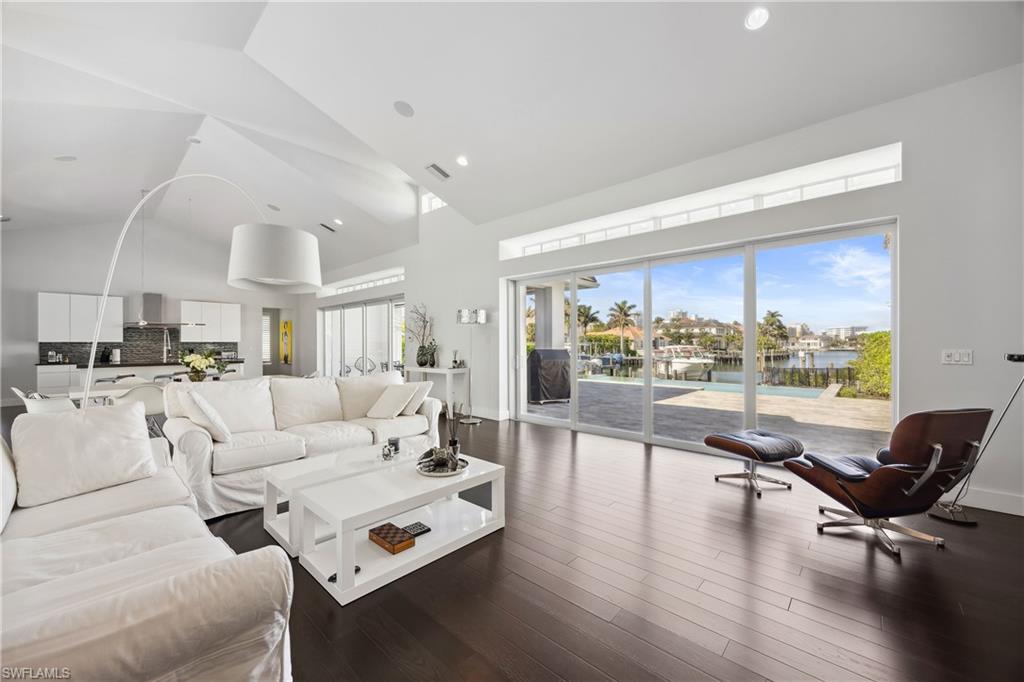 299 Mermaids Bight Naples, FL 34103 - Photo 5 of 28 a living room with furniture and a large window