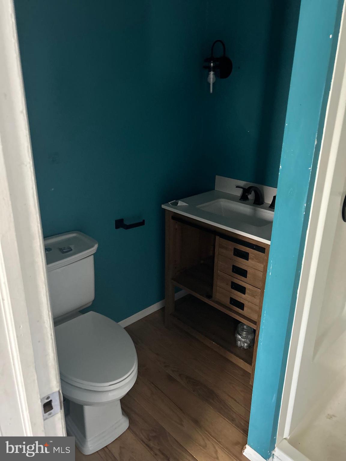 46 Penn Street Penns Grove, NJ 08069 - Photo 13 of 18 a bathroom with a toilet a sink and a vanity