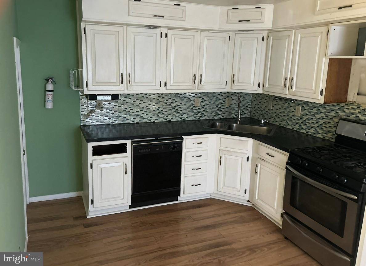 46 Penn Street Penns Grove, NJ 08069 - Photo 2 of 18 a kitchen with granite countertop white cabinets and stainless steel appliances