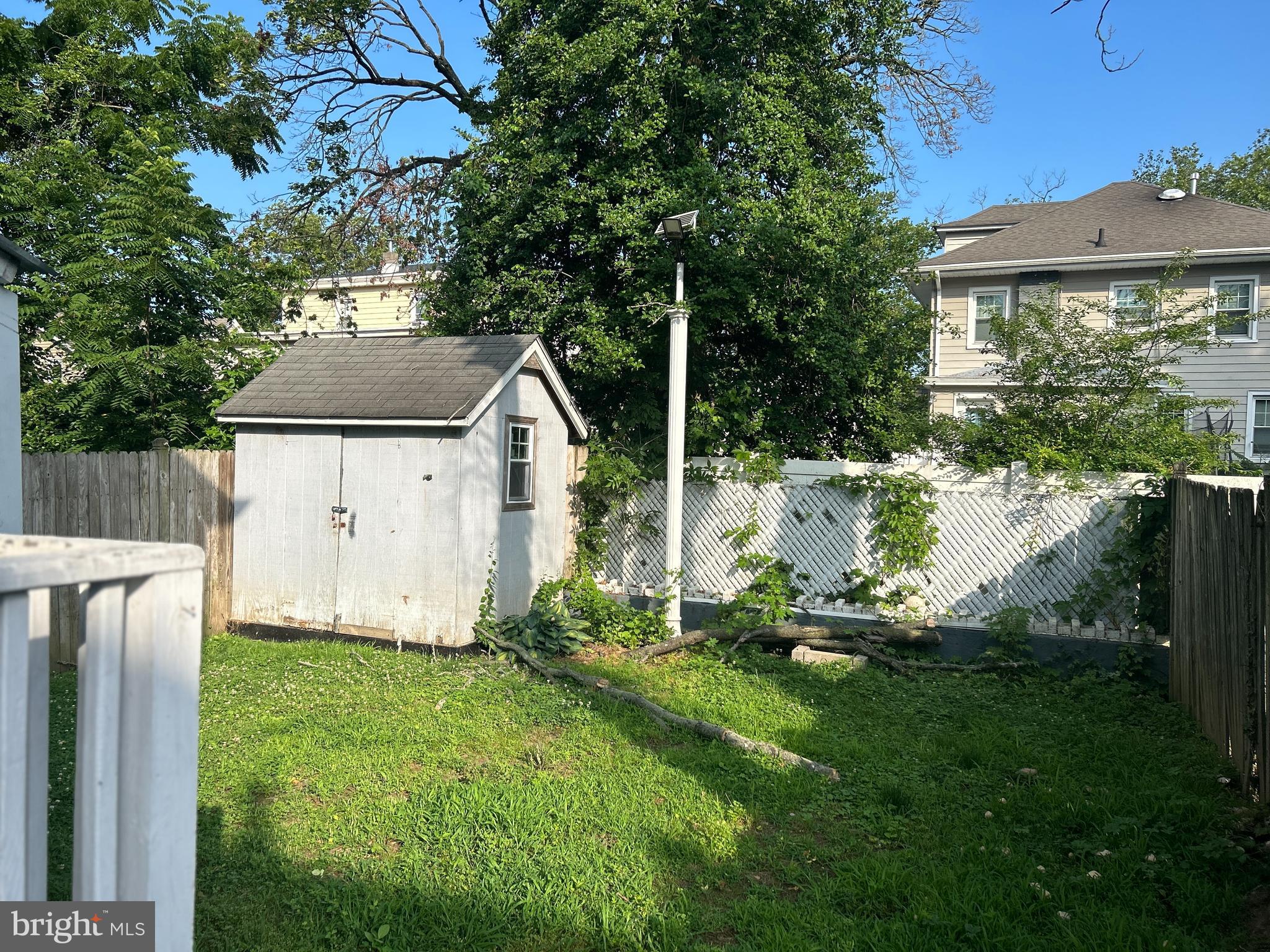 46 Penn Street Penns Grove, NJ 08069 - Photo 10 of 18 a backyard of a house with table and chairs a barbeque with wooden fence