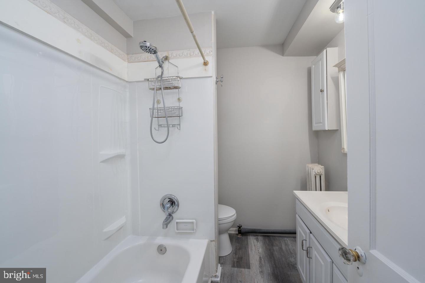 1637 Spence Street Baltimore, MD 21230 - Photo 13 of 22 a bathroom with a granite countertop sink a toilet and shower