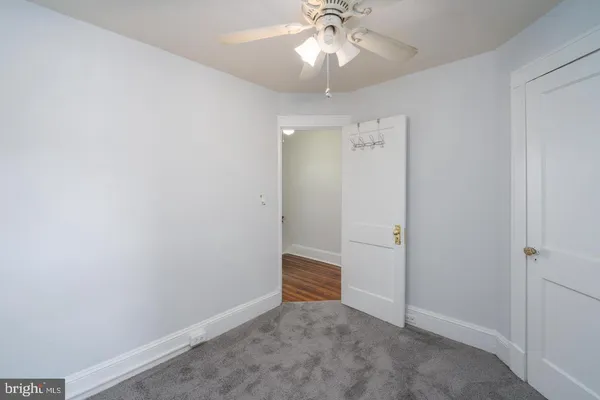 an empty room with wooden floor and closet