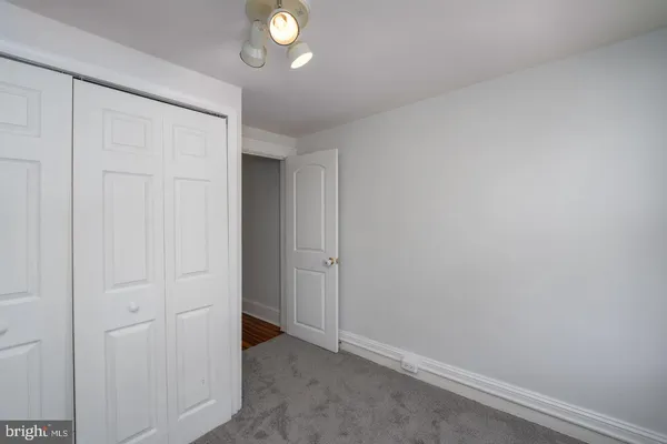 a view of empty room with wooden walls