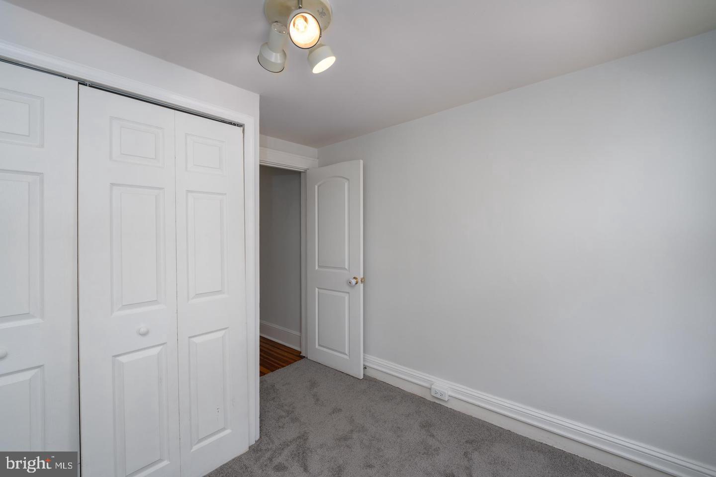 1637 Spence Street Baltimore, MD 21230 - Photo 16 of 22 an empty room with wooden floor and closet