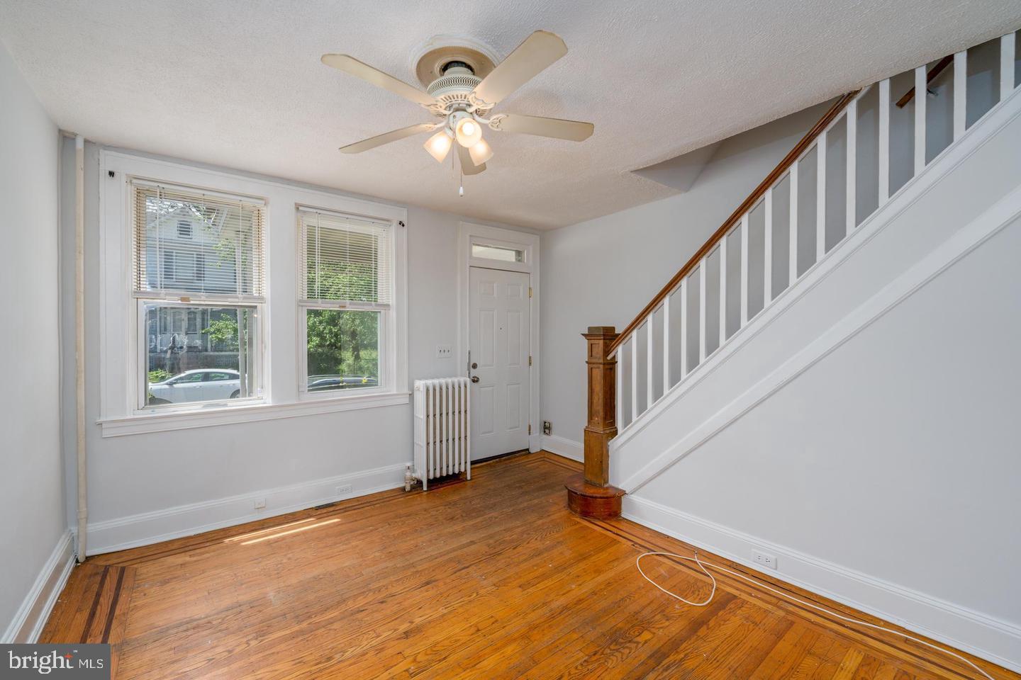 1637 Spence Street Baltimore, MD 21230 - Photo 3 of 22 a view of an empty room with wooden floor and a window