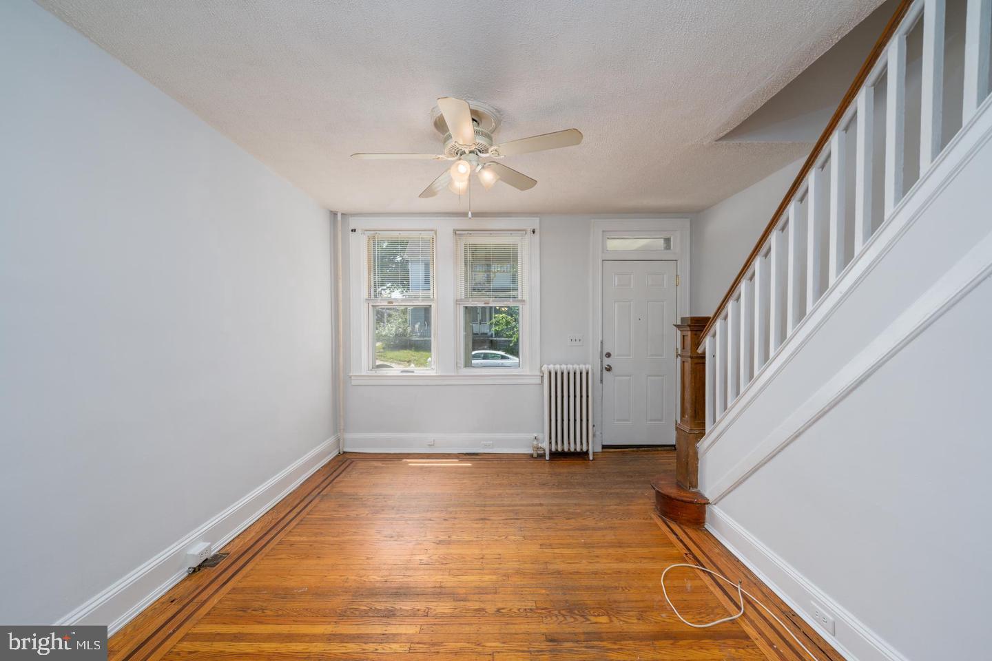 1637 Spence Street Baltimore, MD 21230 - Photo 4 of 22 a view of an empty room with wooden floor and fan