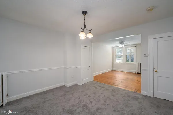 wooden floor in an empty room and a bathroom