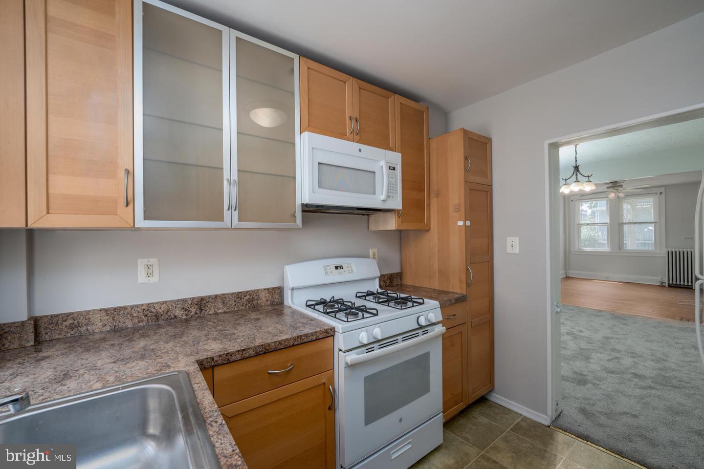 1637 Spence Street Baltimore, MD 21230 - Photo 10 of 22 a kitchen with stainless steel appliances granite countertop a sink stove and cabinets