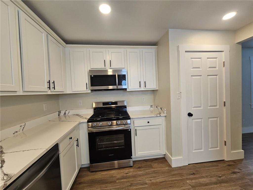 539 Walnut Street Vandergrift, PA 15690 - Photo 6 of 33 a kitchen with stainless steel appliances granite countertop a stove a sink and a refrigerator