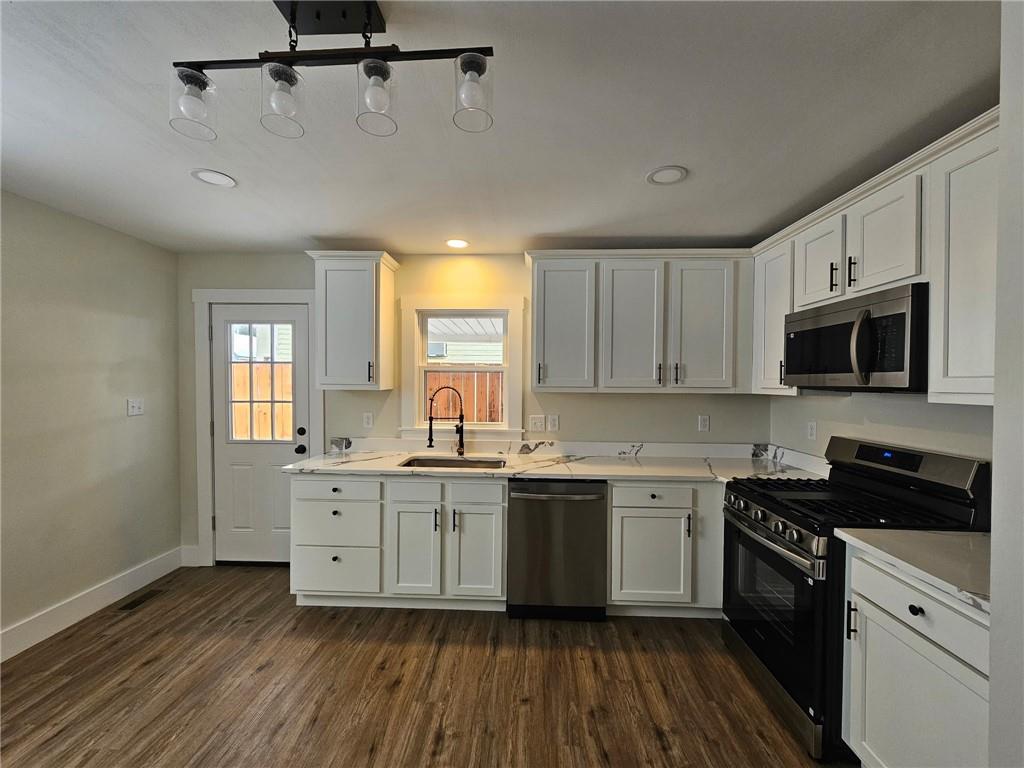 539 Walnut Street Vandergrift, PA 15690 - Photo 7 of 33 a kitchen with stainless steel appliances a sink cabinets and wooden floor