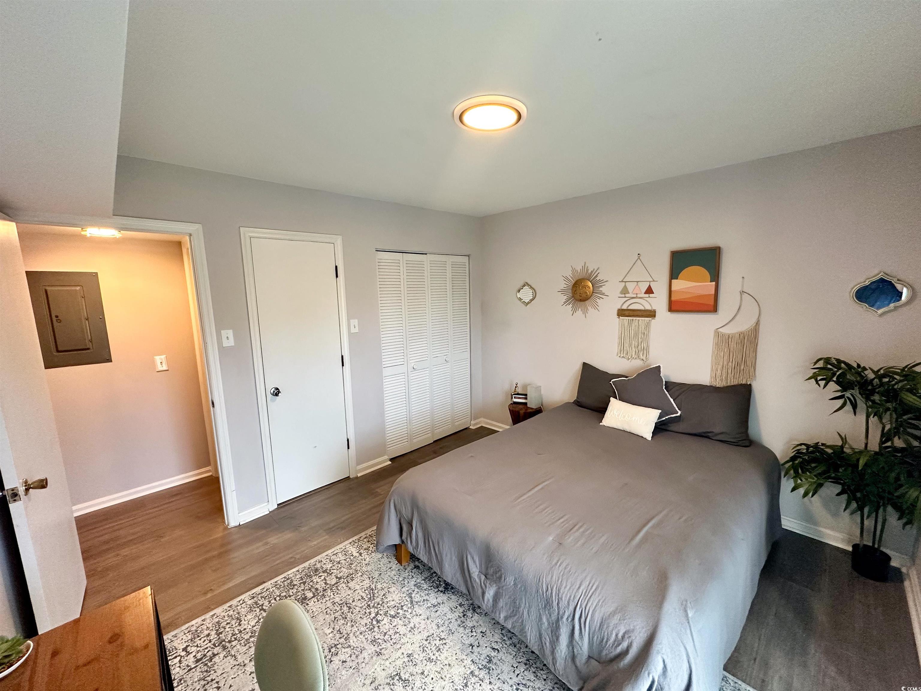 1356 Glenns Bay Road, Unit C202 Surfside Beach, SC 29575 - Photo 13 of 35 Bedroom with dark wood-style floors and baseboards