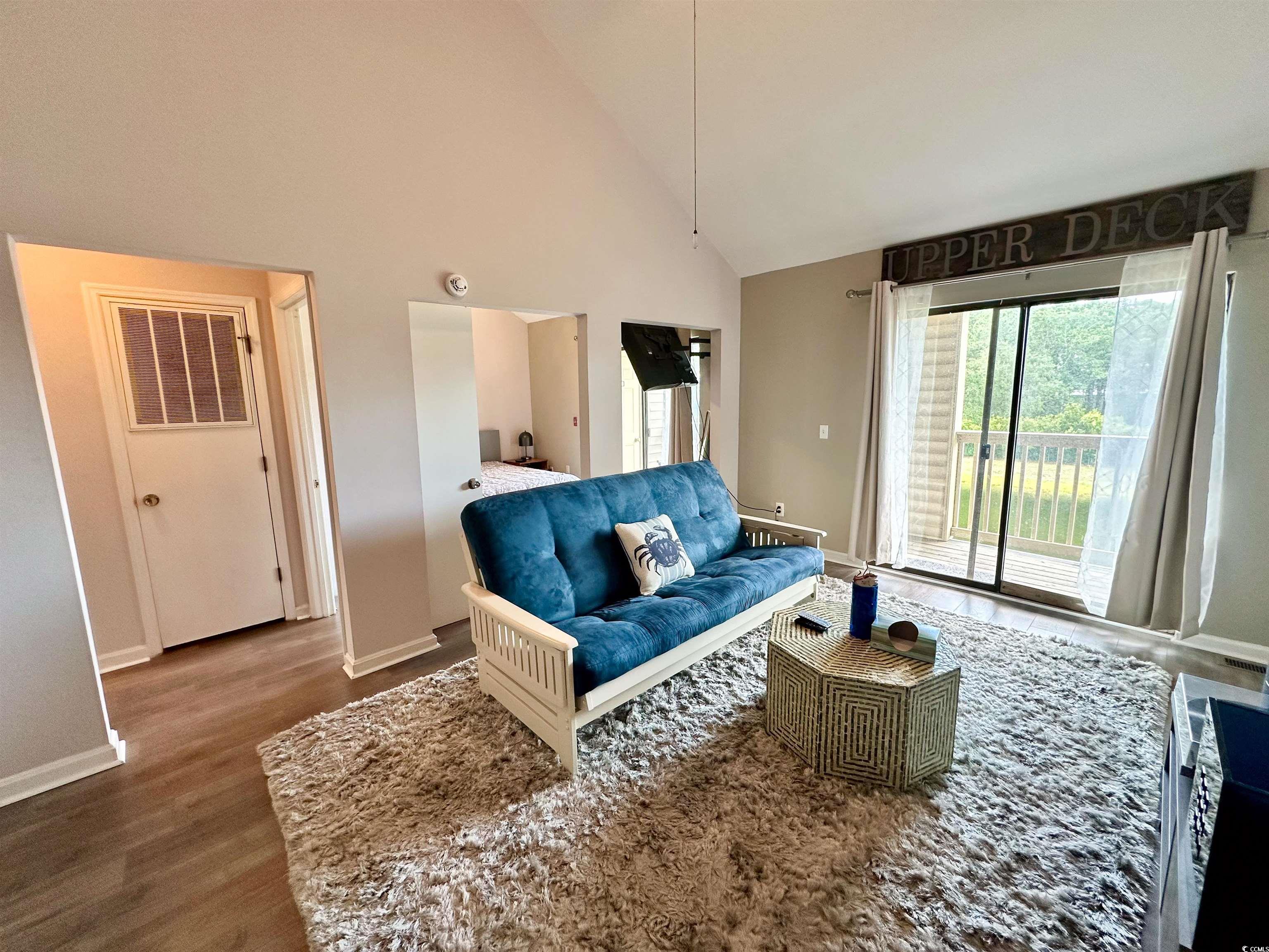 1356 Glenns Bay Road, Unit C202 Surfside Beach, SC 29575 - Photo 22 of 35 Living room featuring high vaulted ceiling, dark wood-type flooring, and ceiling fan