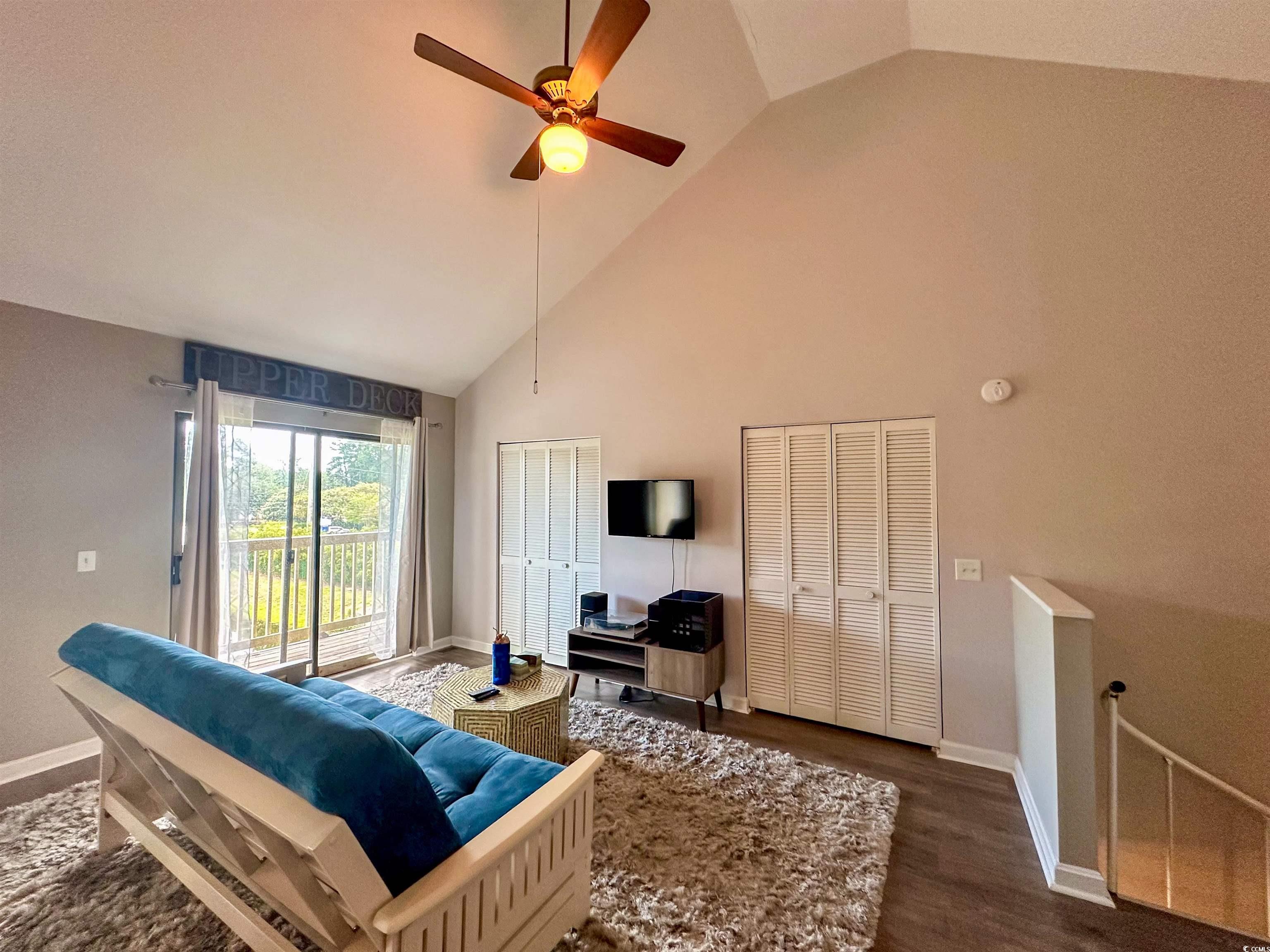 1356 Glenns Bay Road, Unit C202 Surfside Beach, SC 29575 - Photo 23 of 35 Living room featuring high vaulted ceiling, wood finished floors, and healthy amount of natural light