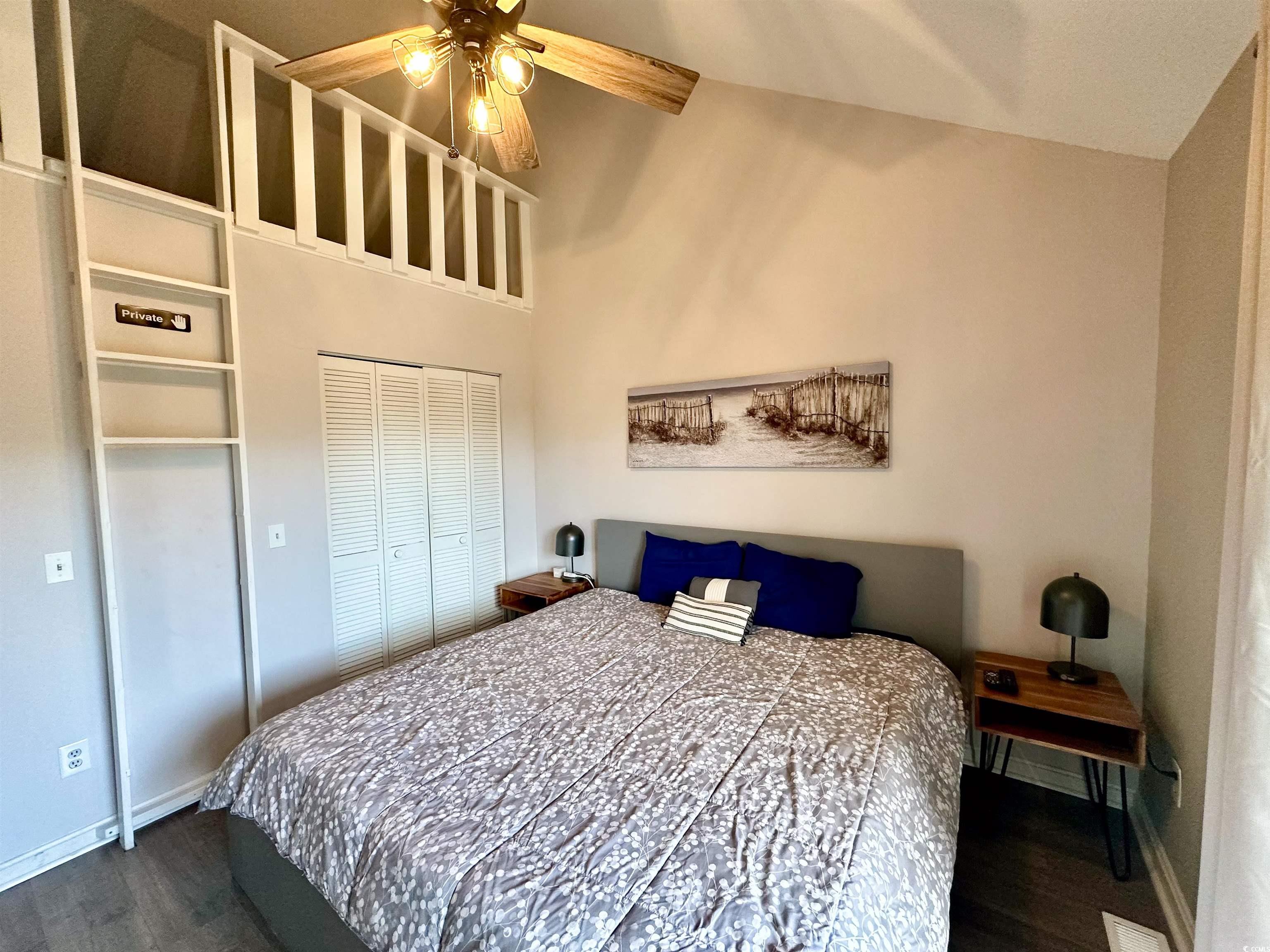 1356 Glenns Bay Road, Unit C202 Surfside Beach, SC 29575 - Photo 25 of 35 Bedroom with wood finished floors, lofted ceiling, a closet, and a ceiling fan