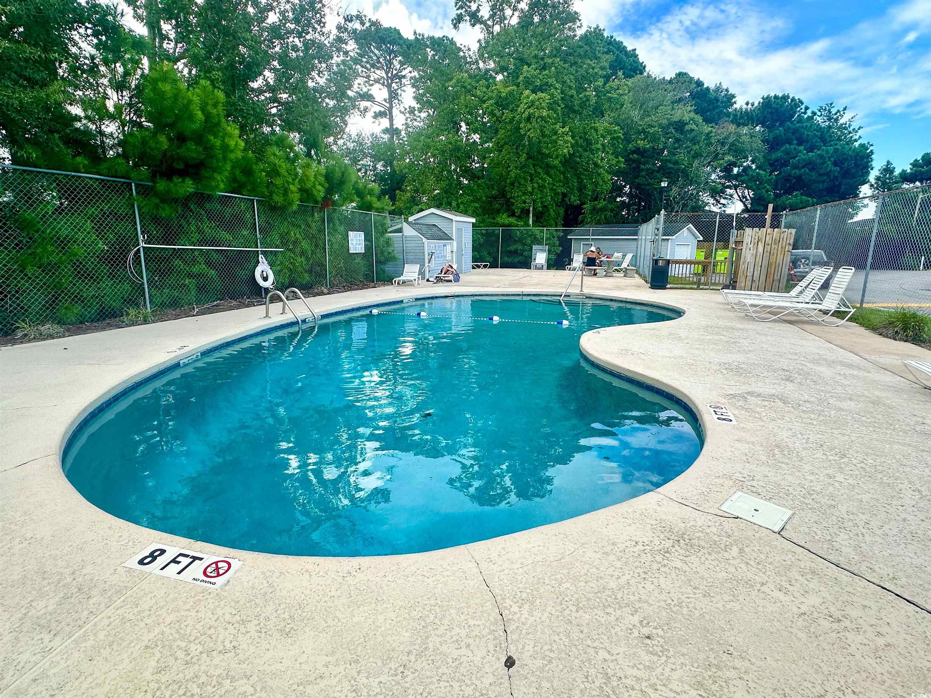 1356 Glenns Bay Road, Unit C202 Surfside Beach, SC 29575 - Photo 33 of 35 Balcony featuring a water view and a sunroom