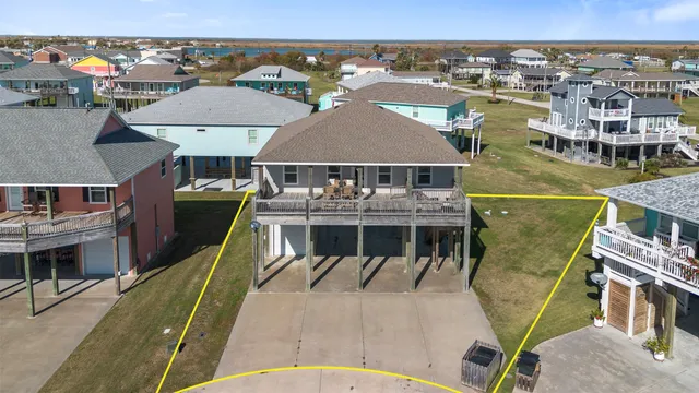 an aerial view of a house with pool table and chairs