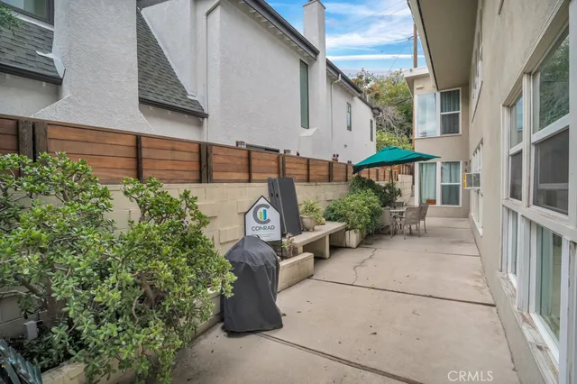 a view of a house with potted plants