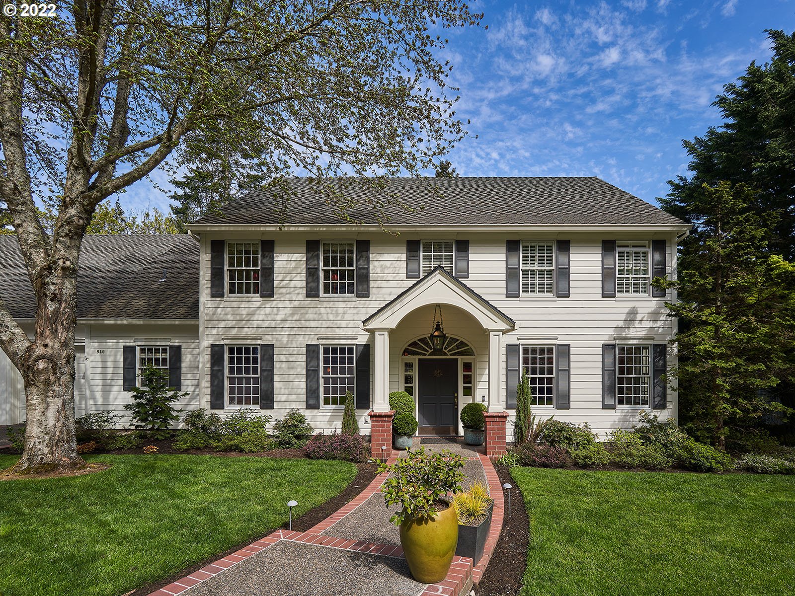 940 Southwest 67th Place Portland, OR 97225 - Photo 1 of 31 a front view of a house with garden