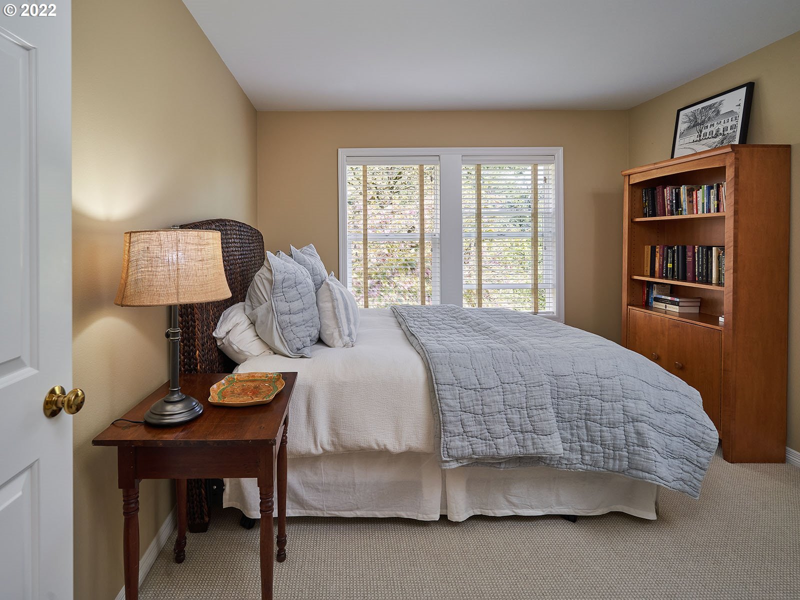 940 Southwest 67th Place Portland, OR 97225 - Photo 20 of 31 a bedroom with a bed table lamp and a window