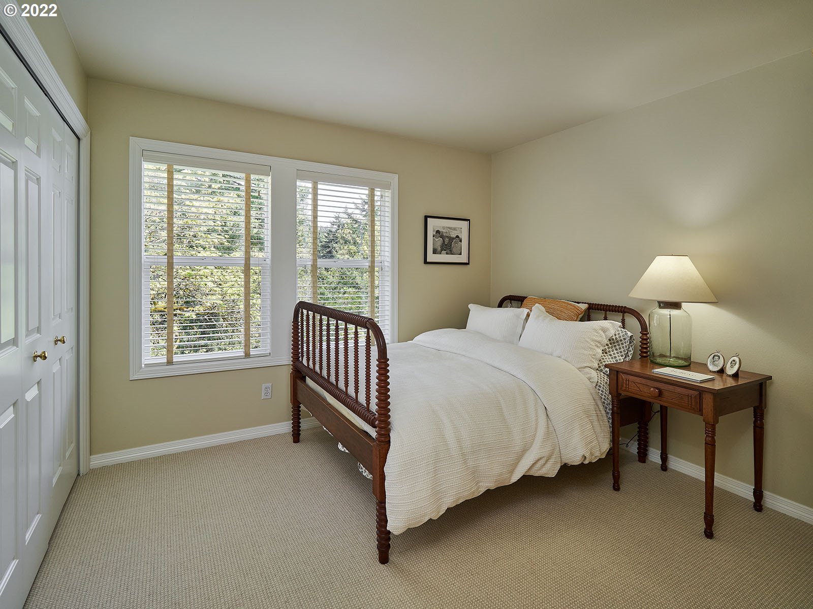 940 Southwest 67th Place Portland, OR 97225 - Photo 21 of 31 a bed room with a bed and a lamp
