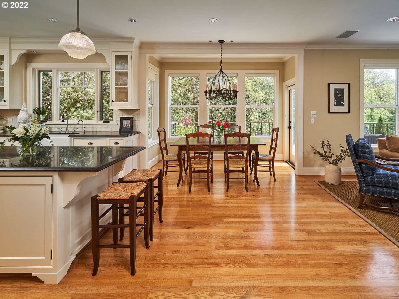 940 Southwest 67th Place Portland, OR 97225 - Photo 7 of 31 a dining room with wooden floor a chandelier a wooden table and chairs