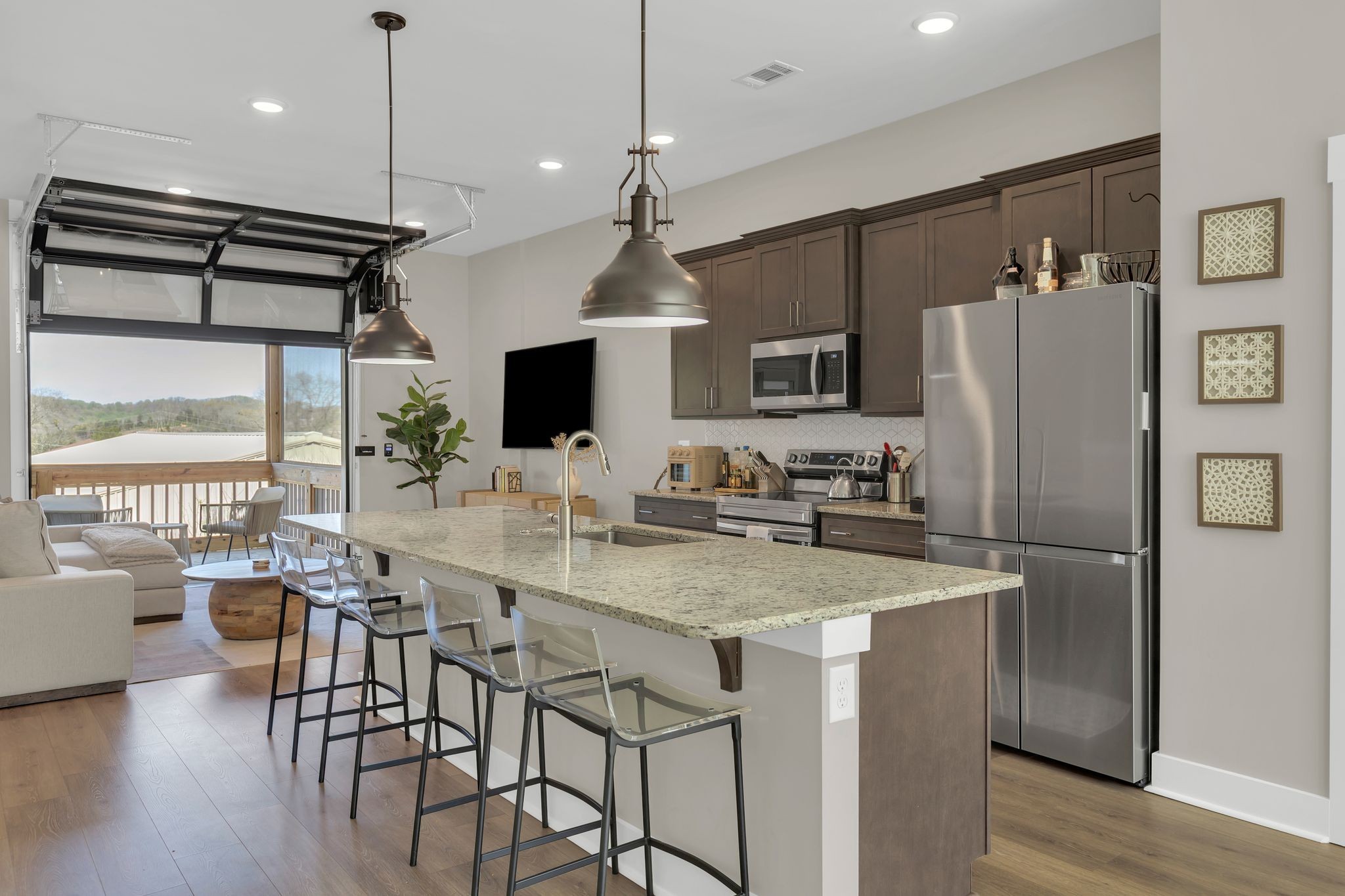 253 Stonecrest Drive Nashville, TN 37209 - Photo 12 of 36 a kitchen with stainless steel appliances granite countertop a refrigerator a sink a stove and a dining table with wooden floor