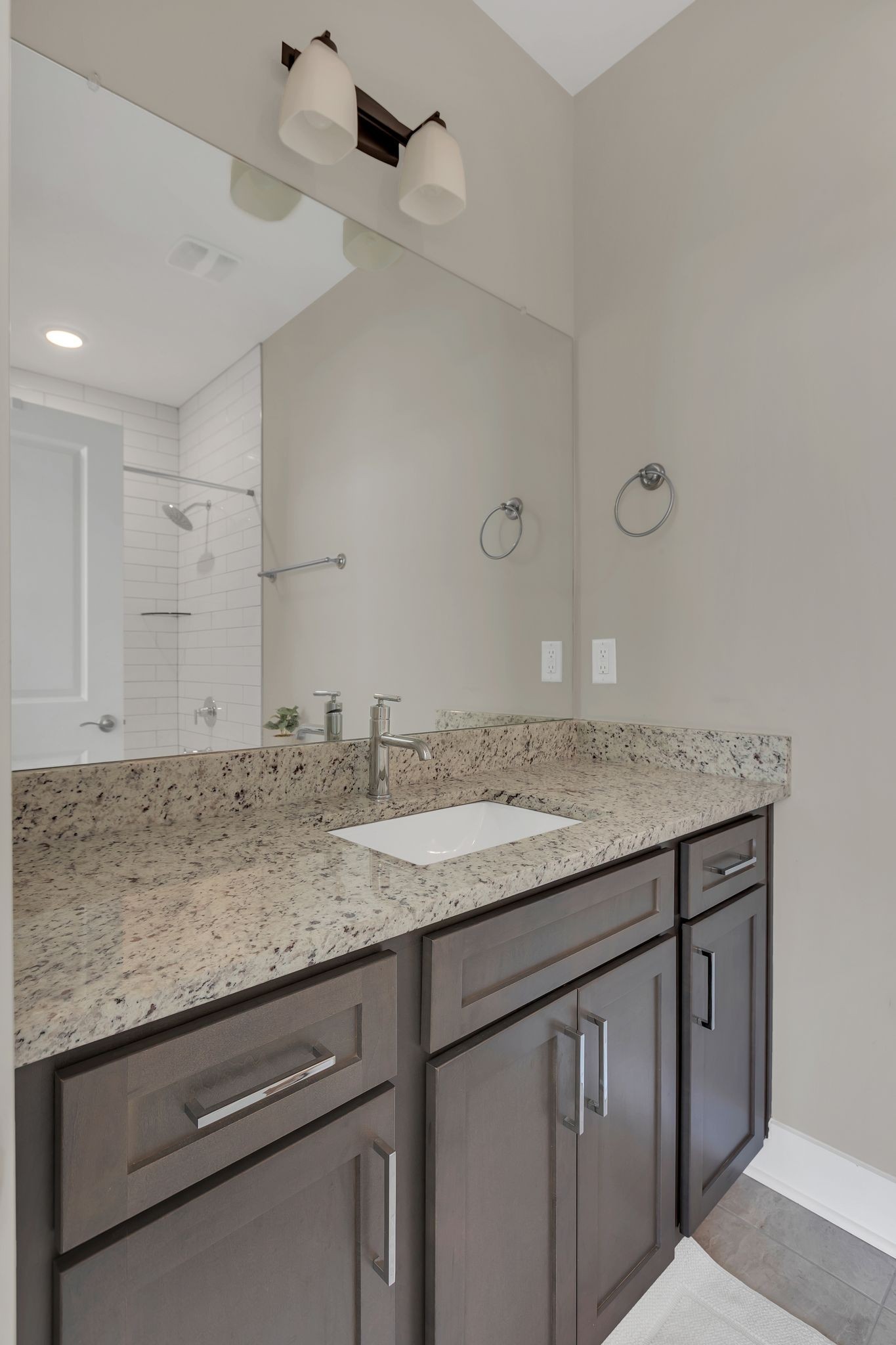 253 Stonecrest Drive Nashville, TN 37209 - Photo 23 of 36 a bathroom with a granite countertop sink and white cabinets