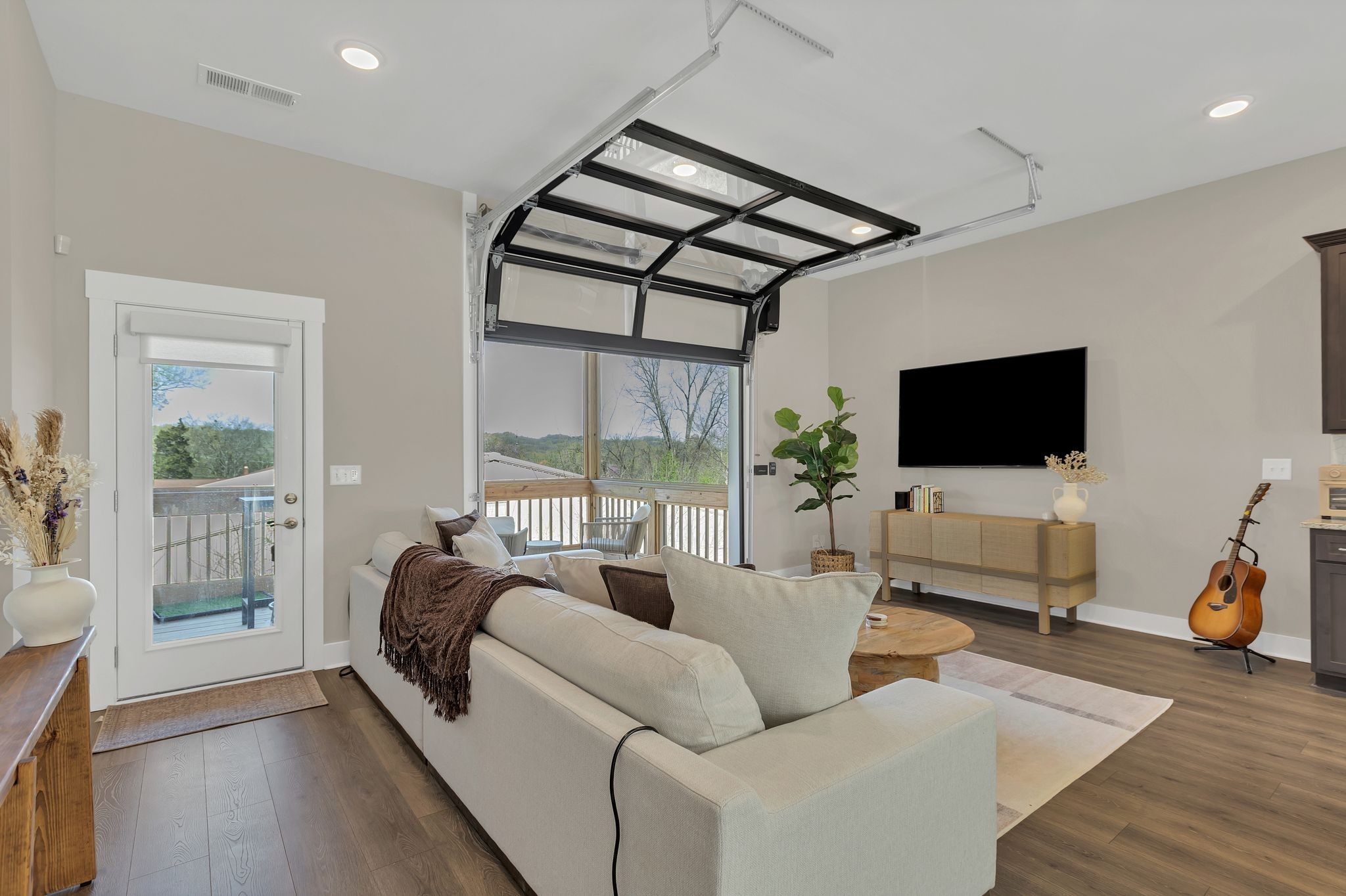 253 Stonecrest Drive Nashville, TN 37209 - Photo 8 of 36 a living room with furniture a flat screen tv and a floor to ceiling window