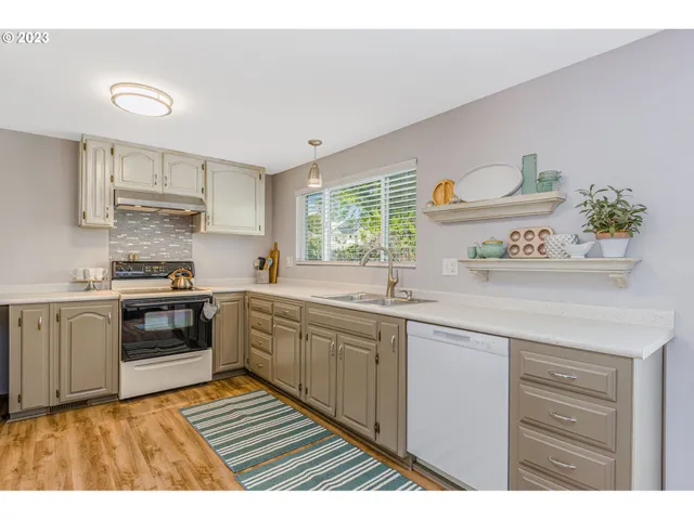 a kitchen with a sink stove and cabinets