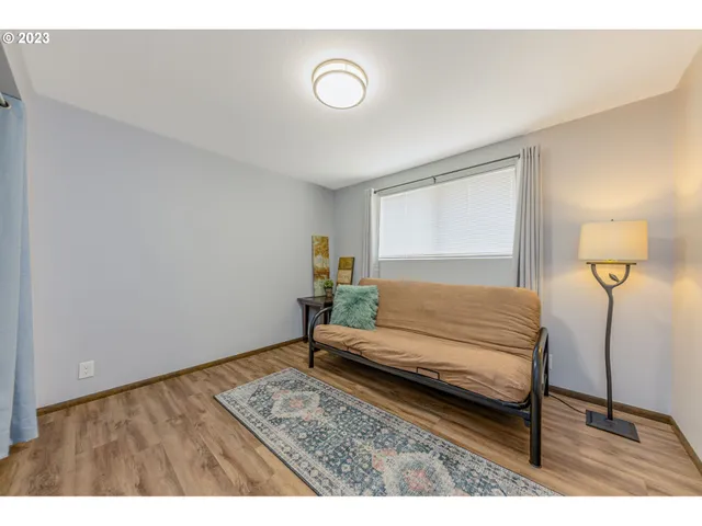 a bedroom with a bed and a night stand