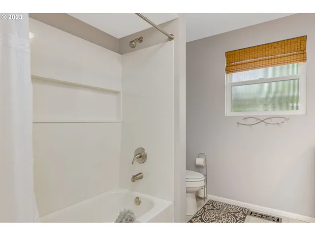 a bathroom with a window and a shower