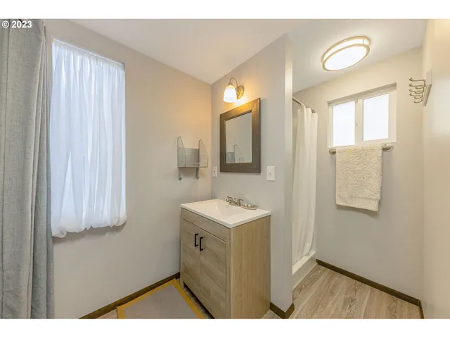 a bathroom with a sink a mirror and a shower