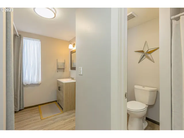 a bathroom with a toilet a sink and mirror