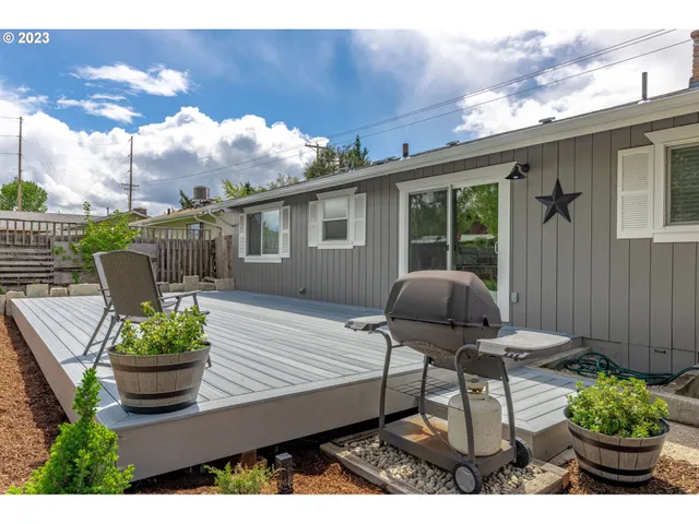 a view of a chairs and table in backyard