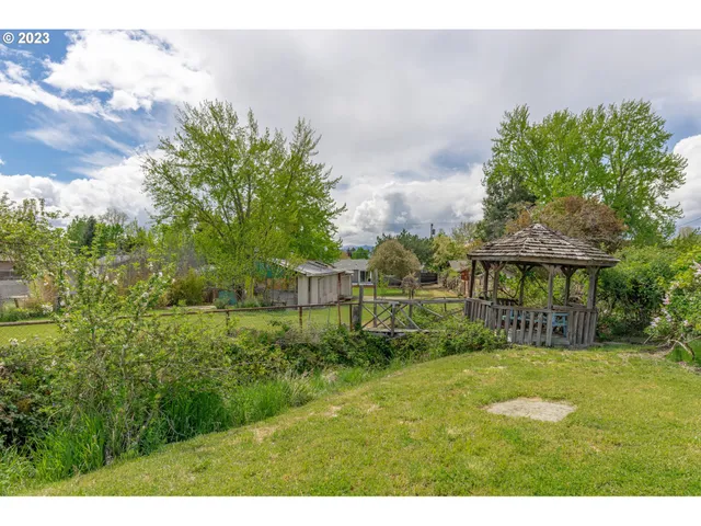 a view of a garden with a building in the background