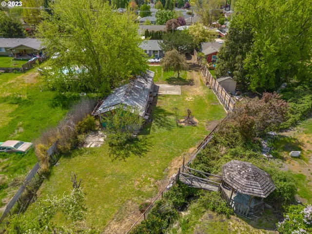 a aerial view of a house with a yard and lake view
