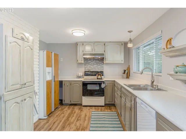 a kitchen with stainless steel appliances granite countertop a stove and a sink