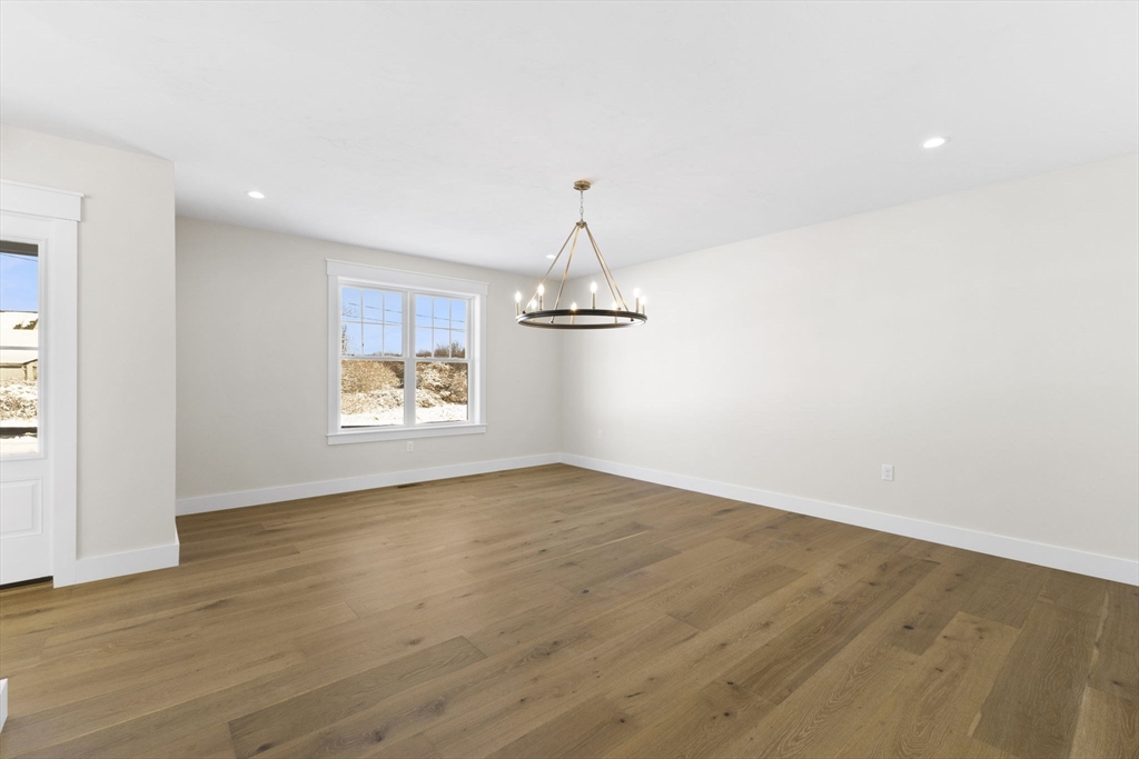 1 Haystack Lane Berkley, MA 02779 - Photo 18 of 33 a view of an empty room with window and wooden floor