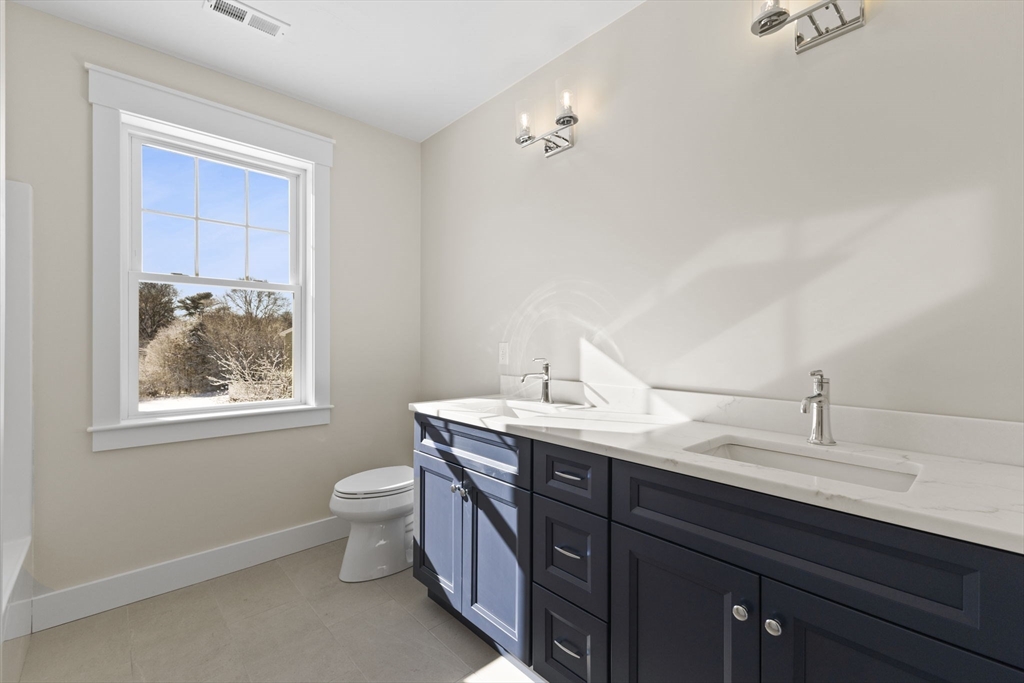 1 Haystack Lane Berkley, MA 02779 - Photo 31 of 33 a en suite bathroom with a double vanity sink toilet and a window