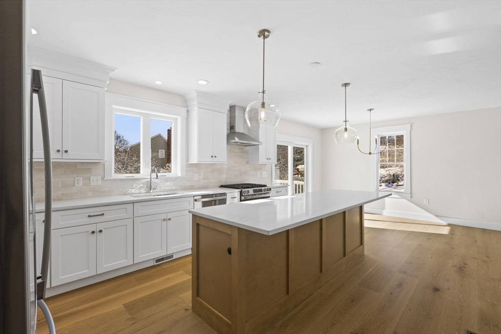 1 Haystack Lane Berkley, MA 02779 - Photo 7 of 33 a large kitchen with stainless steel appliances kitchen island granite countertop a sink a stove and a wooden floors