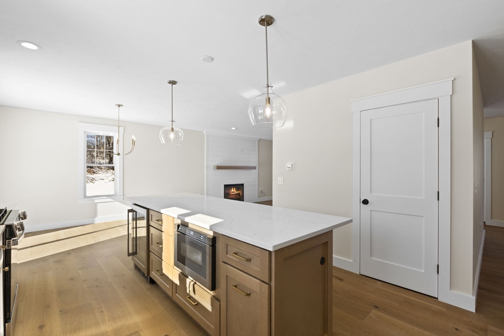 1 Haystack Lane Berkley, MA 02779 - Photo 8 of 33 a view of a kitchen island a sink a refrigerator and wooden floor