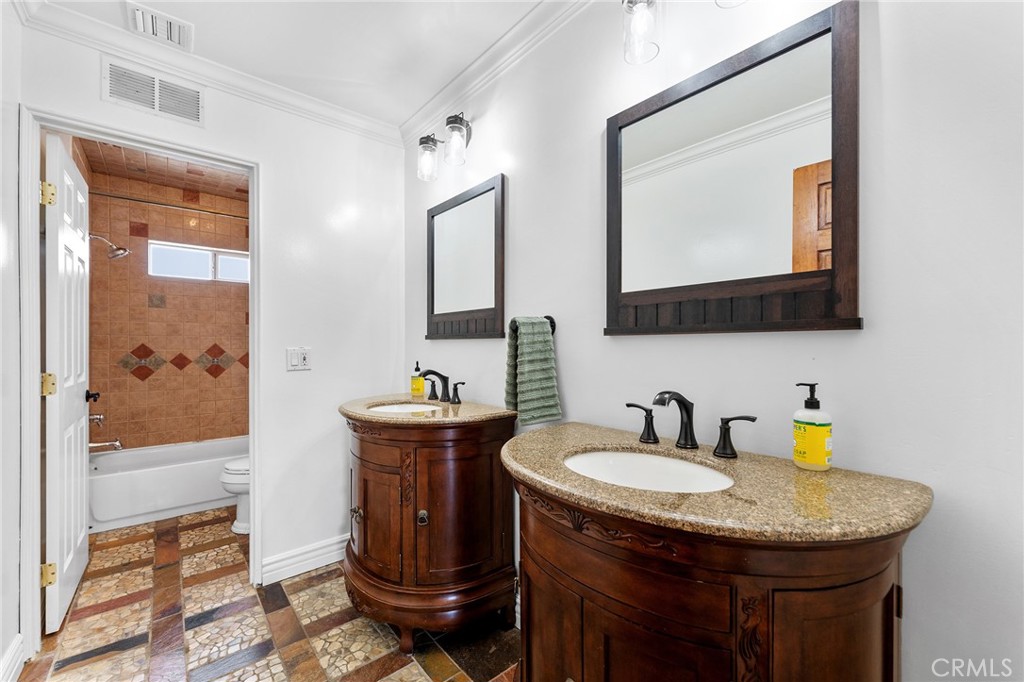 31800 3rd Street Acton, CA 93510 - Photo 18 of 47 a bathroom with a granite countertop sink a mirror and a toilet