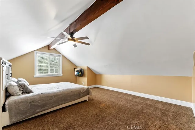 a bedroom with a bed and a ceiling fan